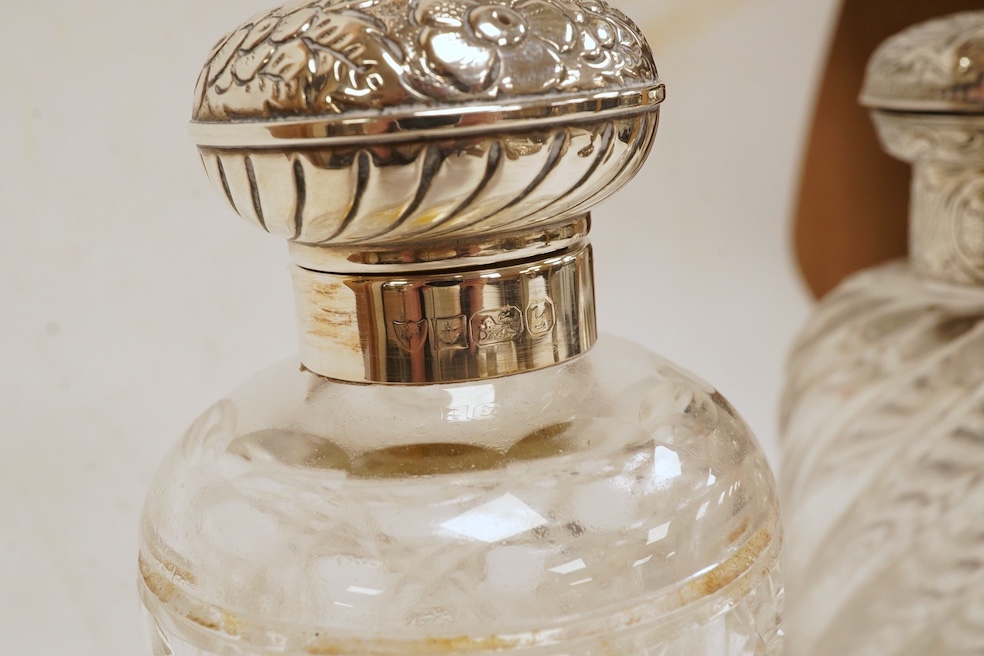 A George III silver helmet shaped cream jug, London, 1796, 14.7cm, together with two silver topped glass scent bottles, one Victorian, a pair of late Victorian silver dwarf candlesticks, London, 1895, a silver mounted ha